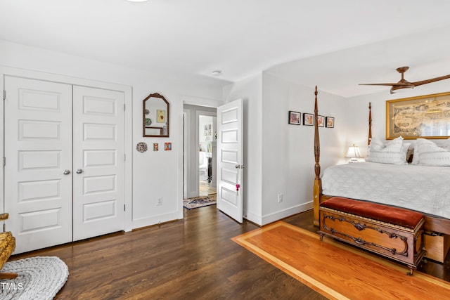 bedroom with dark wood-type flooring, ceiling fan, and a closet