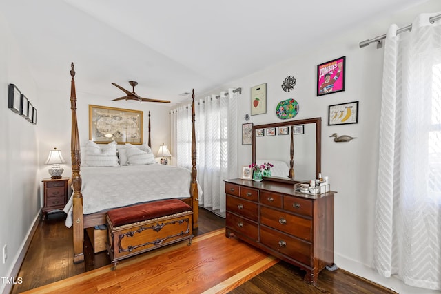 bedroom with dark hardwood / wood-style floors and ceiling fan