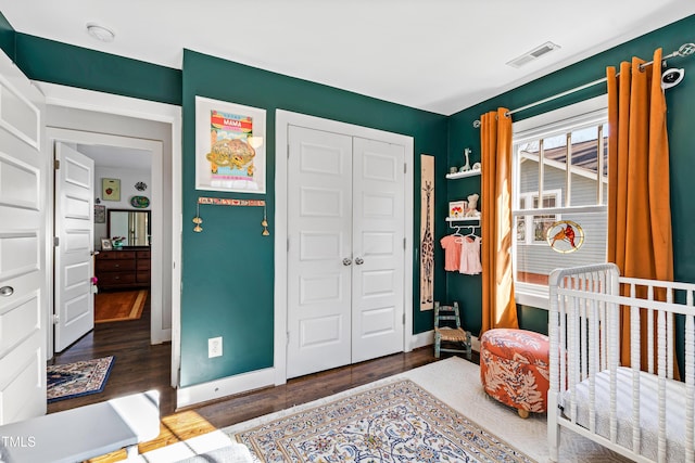 bedroom featuring dark hardwood / wood-style floors and a closet