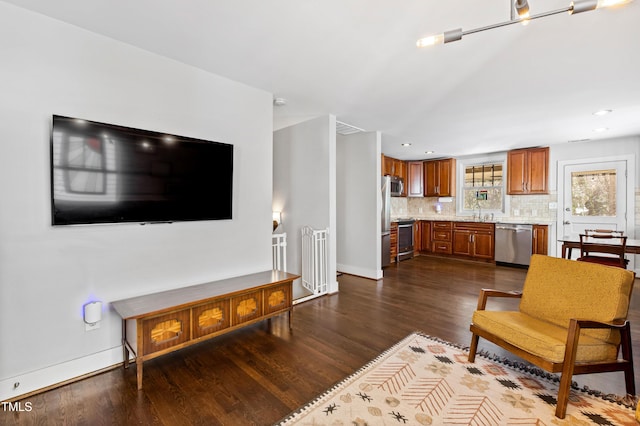 living room with sink and dark hardwood / wood-style floors