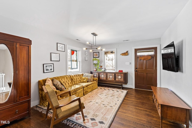 living room featuring dark hardwood / wood-style flooring and a chandelier