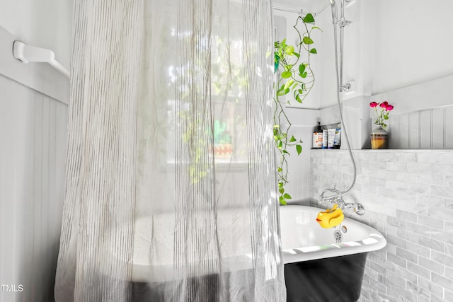 bathroom with a tub to relax in