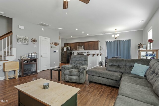 105 Langdon Chase Way, Selma, NC 27576 - living room featuring visible vents, recessed lighting, stairway, dark wood finished floors, and ceiling fan with notable chandelier
