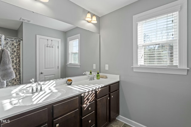 105 Langdon Chase Way, Selma, NC 27576 - full bathroom featuring double vanity, a sink, baseboards, and visible vents