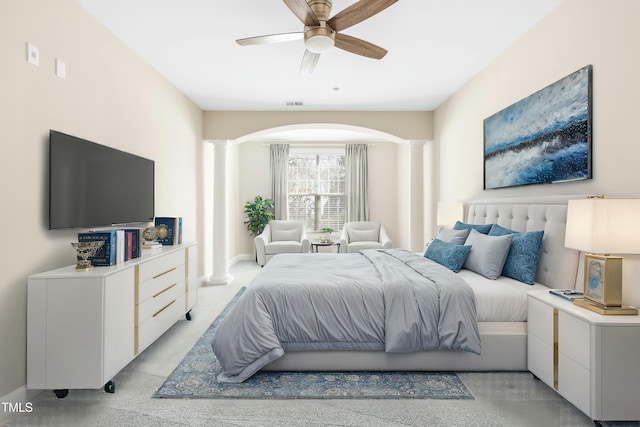 bedroom with ceiling fan and ornate columns