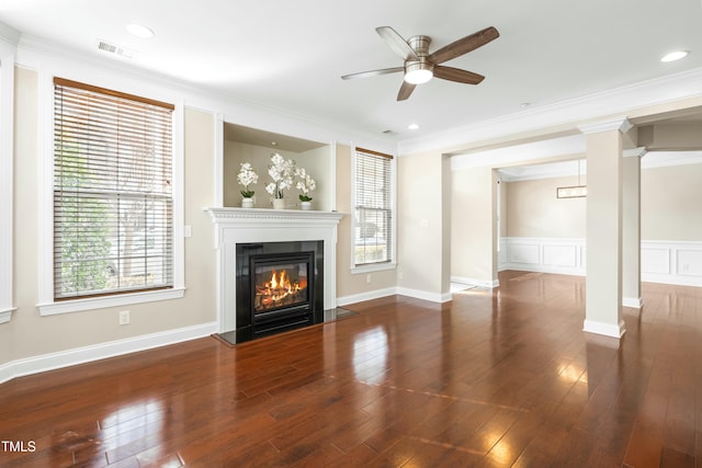 unfurnished living room with crown molding, dark wood-type flooring, and ceiling fan