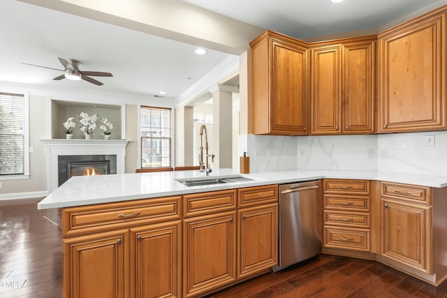 kitchen featuring dark wood-type flooring, stainless steel dishwasher, kitchen peninsula, and sink