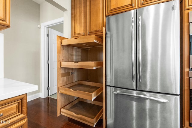 kitchen featuring dark hardwood / wood-style flooring and stainless steel refrigerator