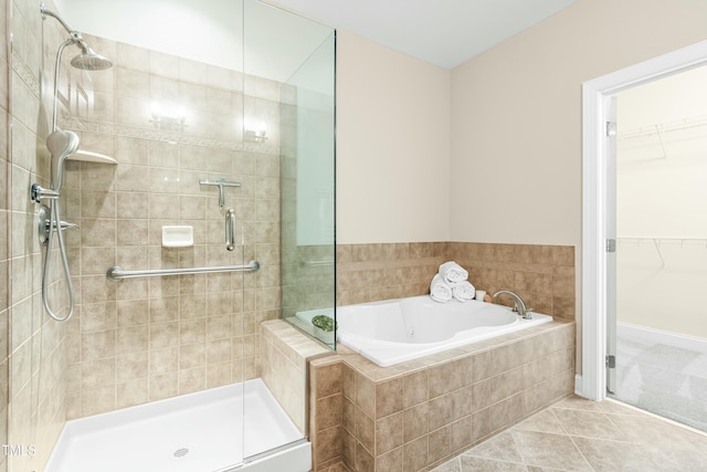 bathroom with tile patterned flooring and shower with separate bathtub