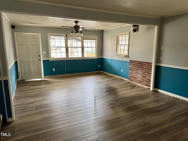 interior space featuring crown molding, ceiling fan, hardwood / wood-style floors, and a textured ceiling