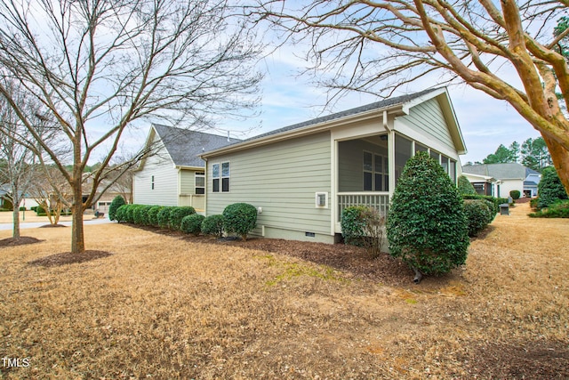 view of property exterior with a sunroom