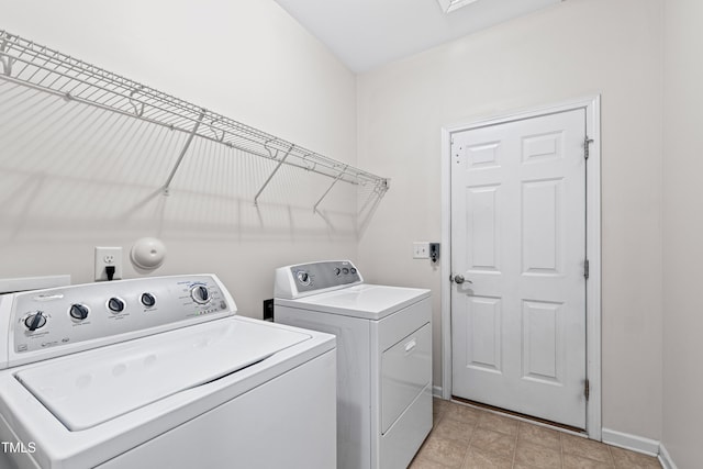 clothes washing area featuring washer and clothes dryer