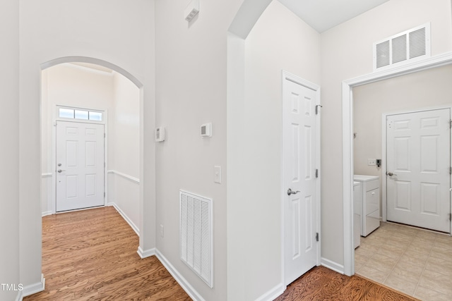 foyer featuring independent washer and dryer and light wood-type flooring