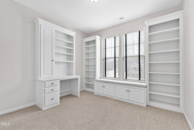 spacious closet featuring light colored carpet