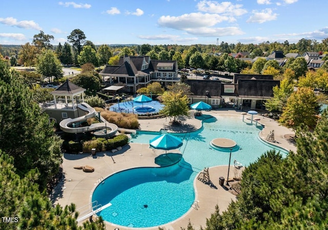 view of pool featuring a gazebo, a water slide, and a patio