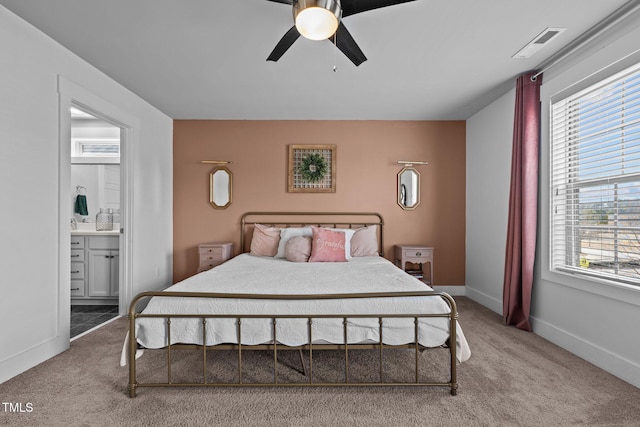 carpeted bedroom featuring ensuite bathroom and ceiling fan