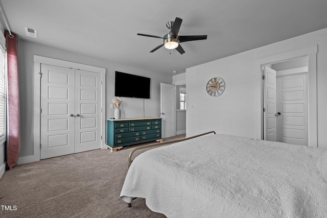 carpeted bedroom featuring ceiling fan and a closet