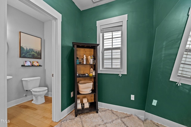 bathroom featuring hardwood / wood-style floors and toilet