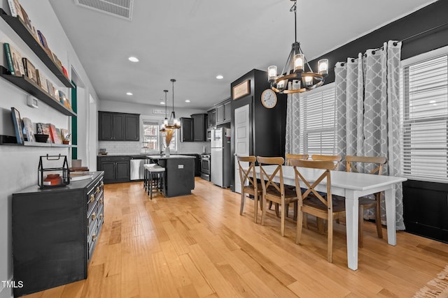 dining room featuring a chandelier and light hardwood / wood-style flooring