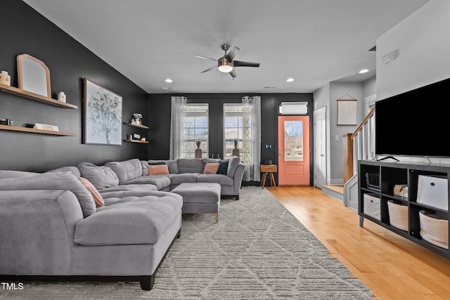 living room with ceiling fan and wood-type flooring