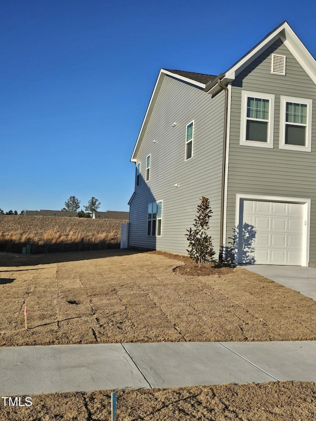 view of side of home featuring a garage