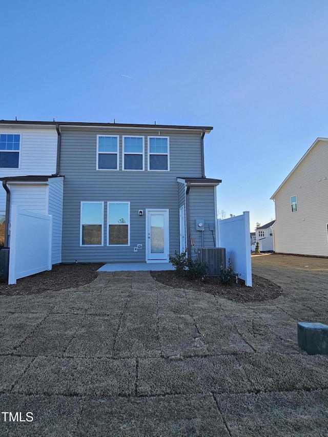 view of front of property featuring a patio and central air condition unit