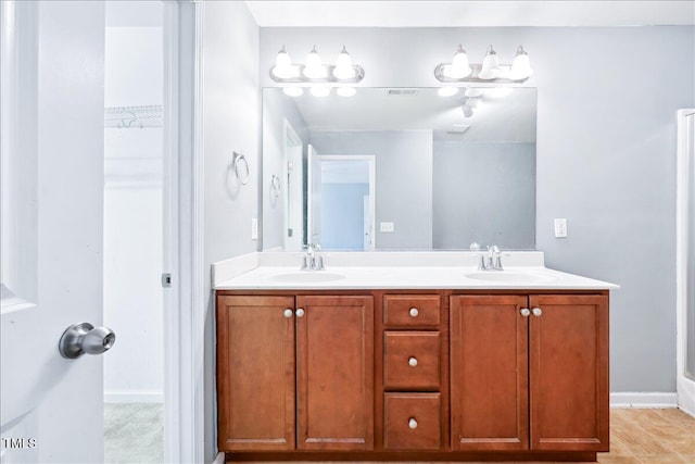 5879 Odenton Ln, Pfafftown, NC 27040 - bathroom with double vanity and baseboards
