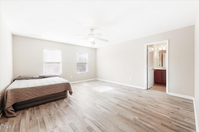 5879 Odenton Ln, Pfafftown, NC 27040 - bedroom with light wood-style flooring, baseboards, connected bathroom, and a ceiling fan