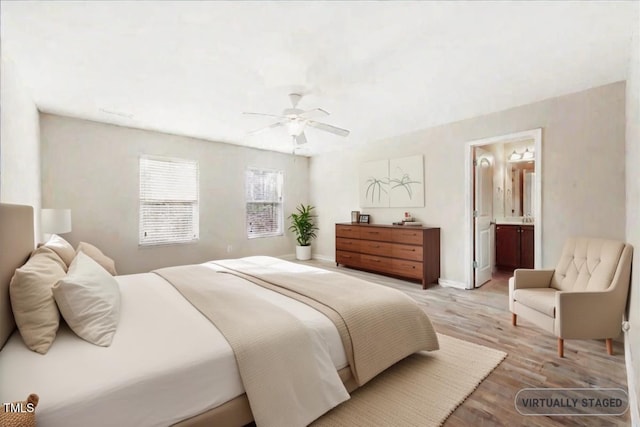 5879 Odenton Ln, Pfafftown, NC 27040 - bedroom with light wood-style floors, connected bathroom, ceiling fan, and baseboards