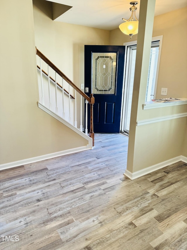 5879 Odenton Ln, Pfafftown, NC 27040 - entrance foyer featuring stairway, wood finished floors, and baseboards