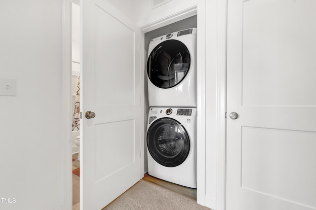 laundry area featuring stacked washer and clothes dryer