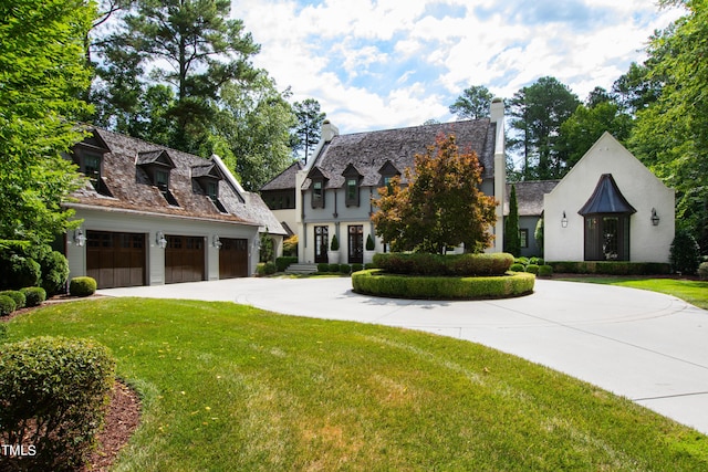 view of front of property with a garage and a front lawn