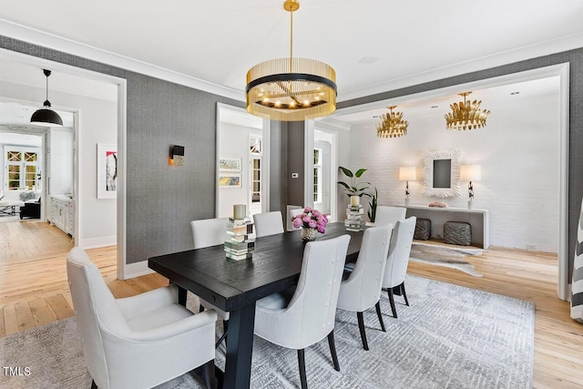 dining area with a chandelier and light hardwood / wood-style floors