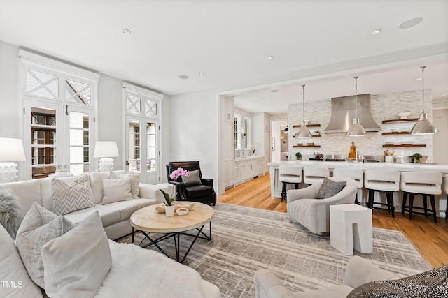 living room featuring french doors and light hardwood / wood-style flooring