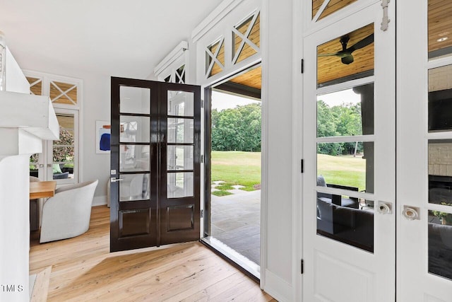 entryway featuring a wealth of natural light, light wood-type flooring, and french doors