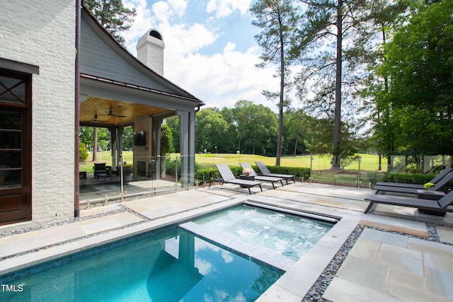 view of pool featuring an in ground hot tub, ceiling fan, and a patio