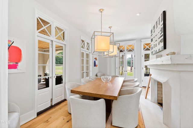 dining room with light hardwood / wood-style flooring and french doors