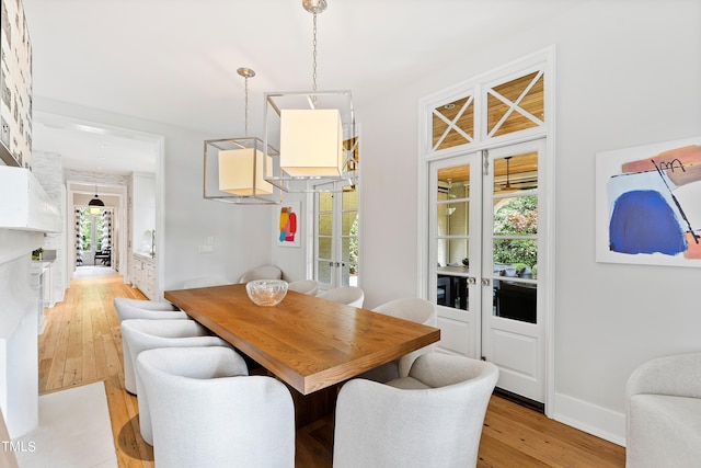 dining space featuring light hardwood / wood-style flooring and french doors