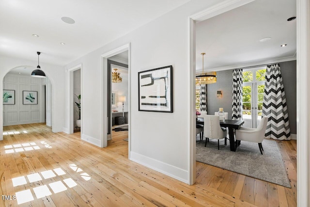 hallway with french doors and light hardwood / wood-style floors