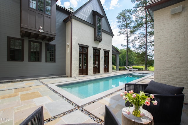 view of swimming pool with a patio area