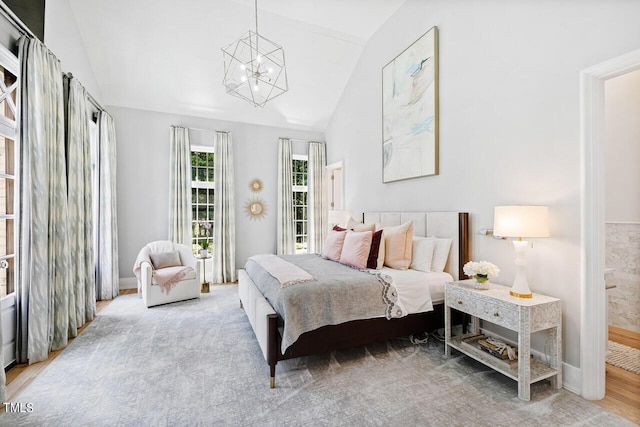 bedroom featuring lofted ceiling and a chandelier