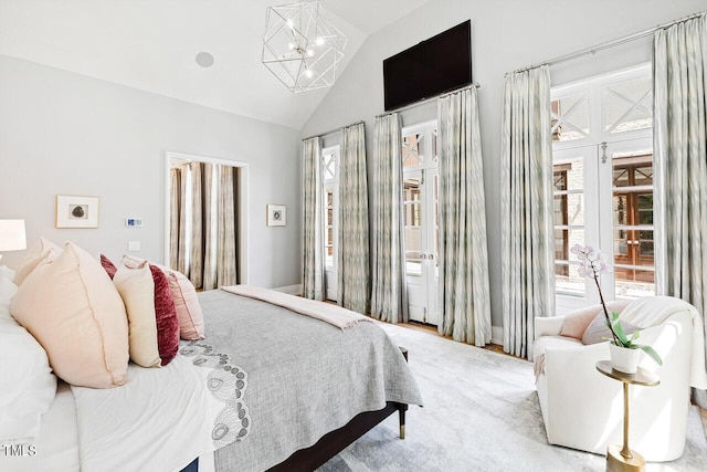 bedroom featuring high vaulted ceiling, light carpet, access to exterior, and an inviting chandelier