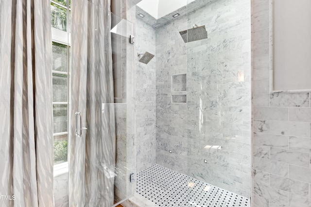 bathroom with a tile shower