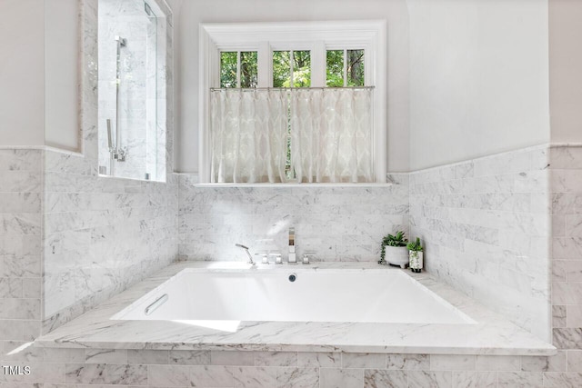 bathroom featuring tiled bath