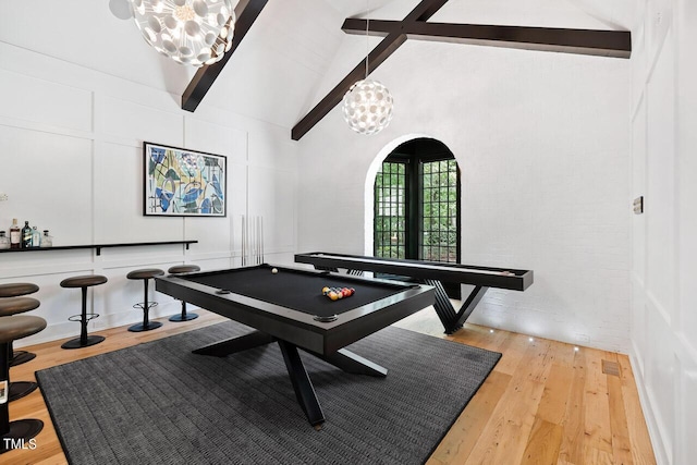 recreation room with high vaulted ceiling, hardwood / wood-style floors, a notable chandelier, and beam ceiling