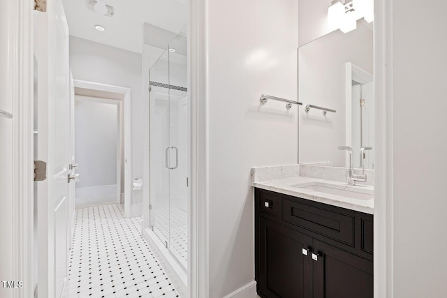 bathroom featuring vanity and an enclosed shower