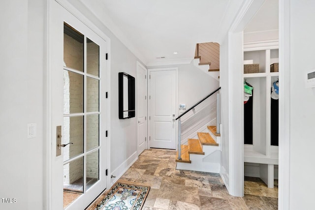 foyer featuring ornamental molding