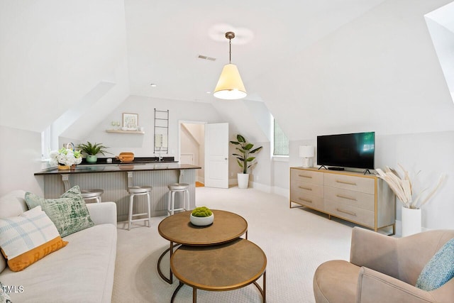 carpeted living room with lofted ceiling