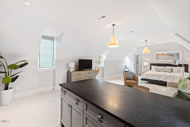 bedroom with light carpet and vaulted ceiling