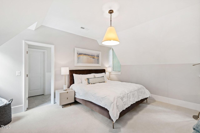 carpeted bedroom with lofted ceiling